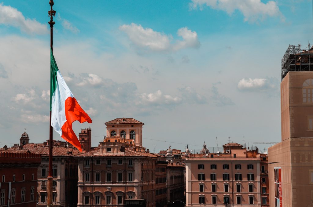 Italian flag flying over an Italian city