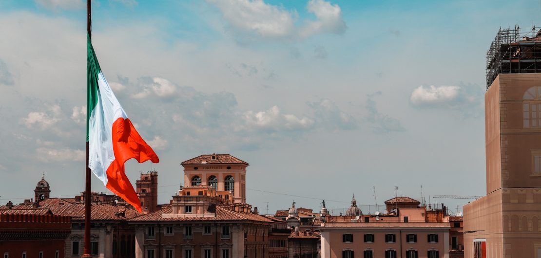 Italian flag flying over an Italian city