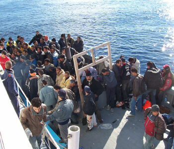 Photo of refugees on a beat in the Mediterranean