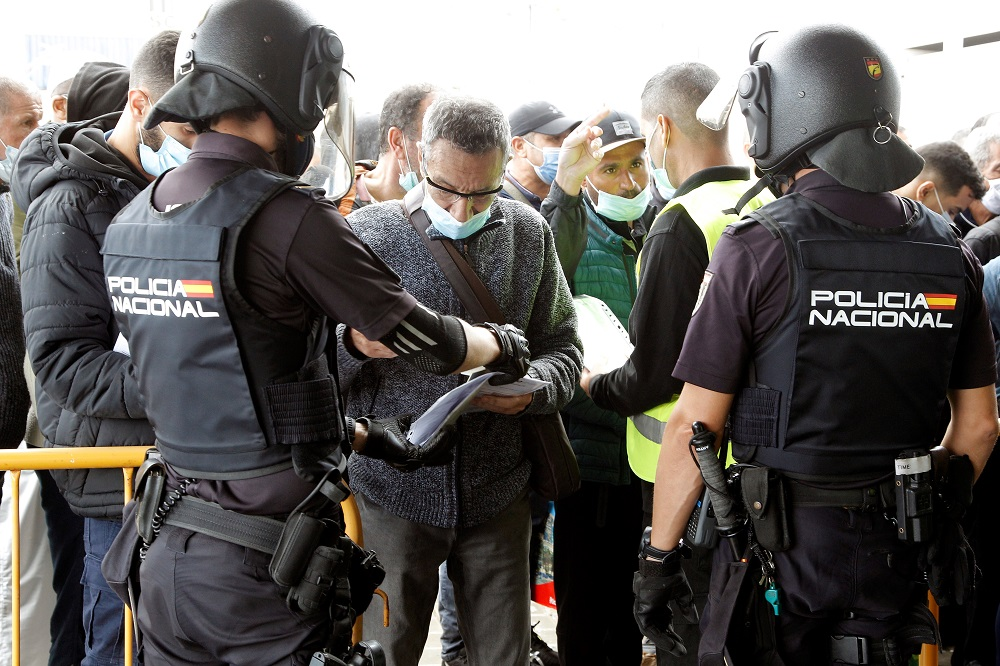 Members of the Spanish National Police check travelers upon arrival to Alicante, Spain, 22 October 2021. EPA-EFE/MORELL