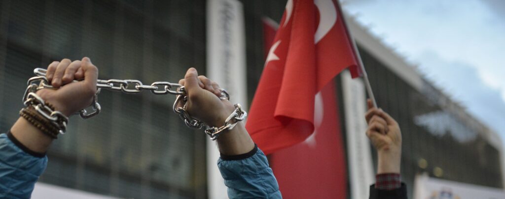 A protester chaining hands during freedom of the press in Istanbul, Turkey, 4 March 2016