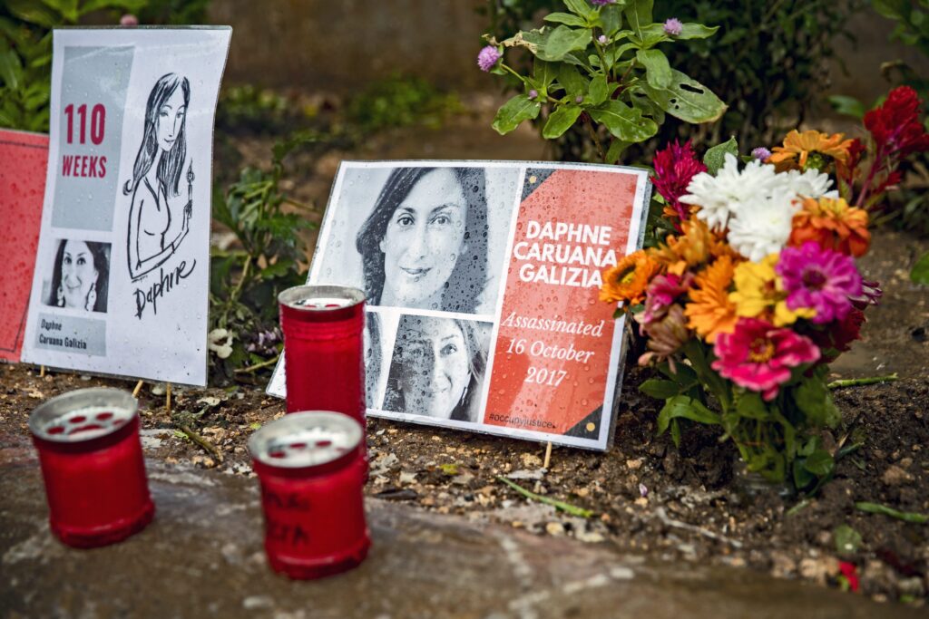 Flowers and light candles are put in memory of murdered journalist Daphne Caruana Galizia at a makeshift memorial outside the law courts in Valletta, Malta on November 25, 2019. (Photo by Emmanuele Contini/NurPhoto)